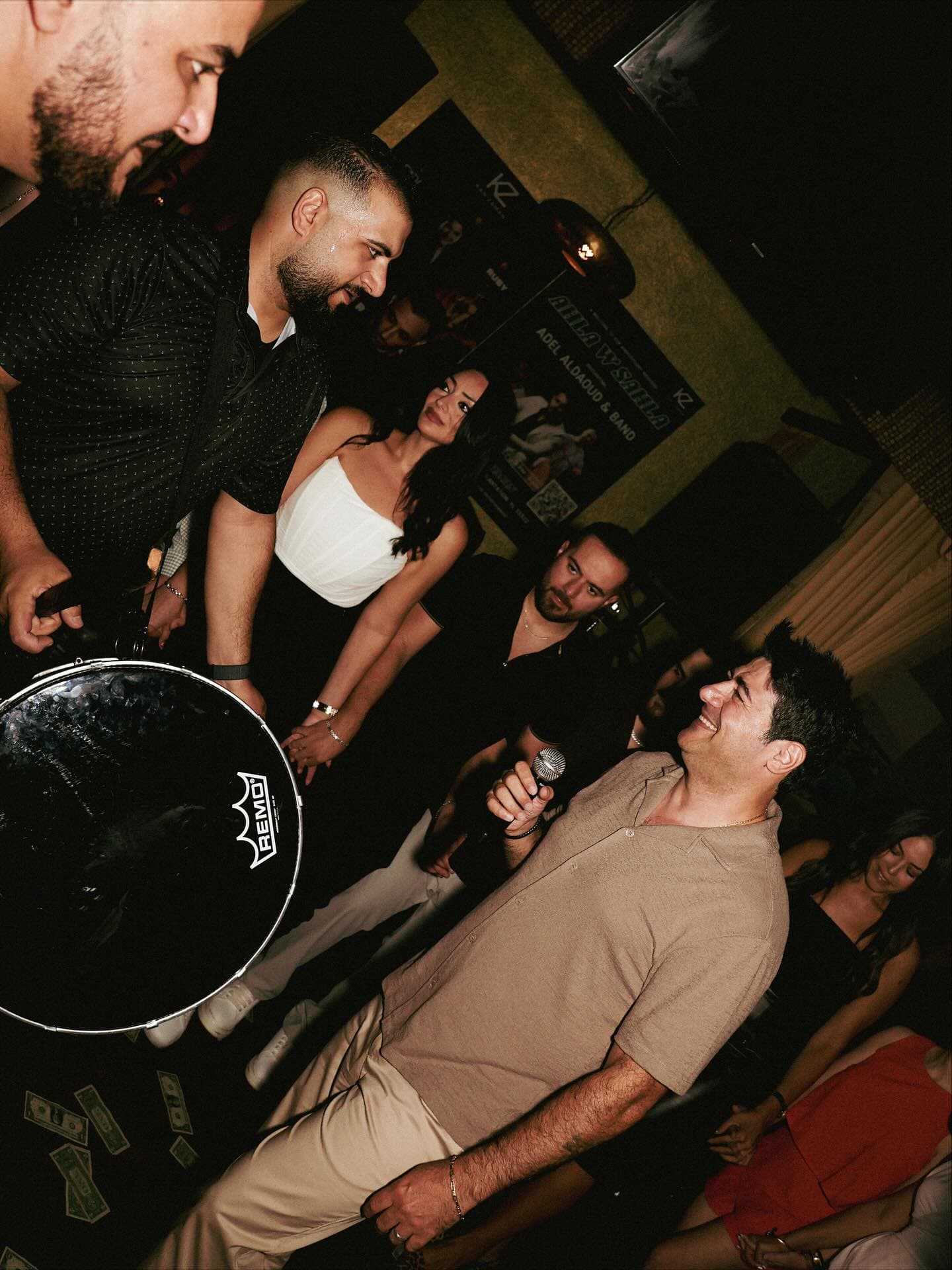 The band in the middle of the room, drum first, tables packed
